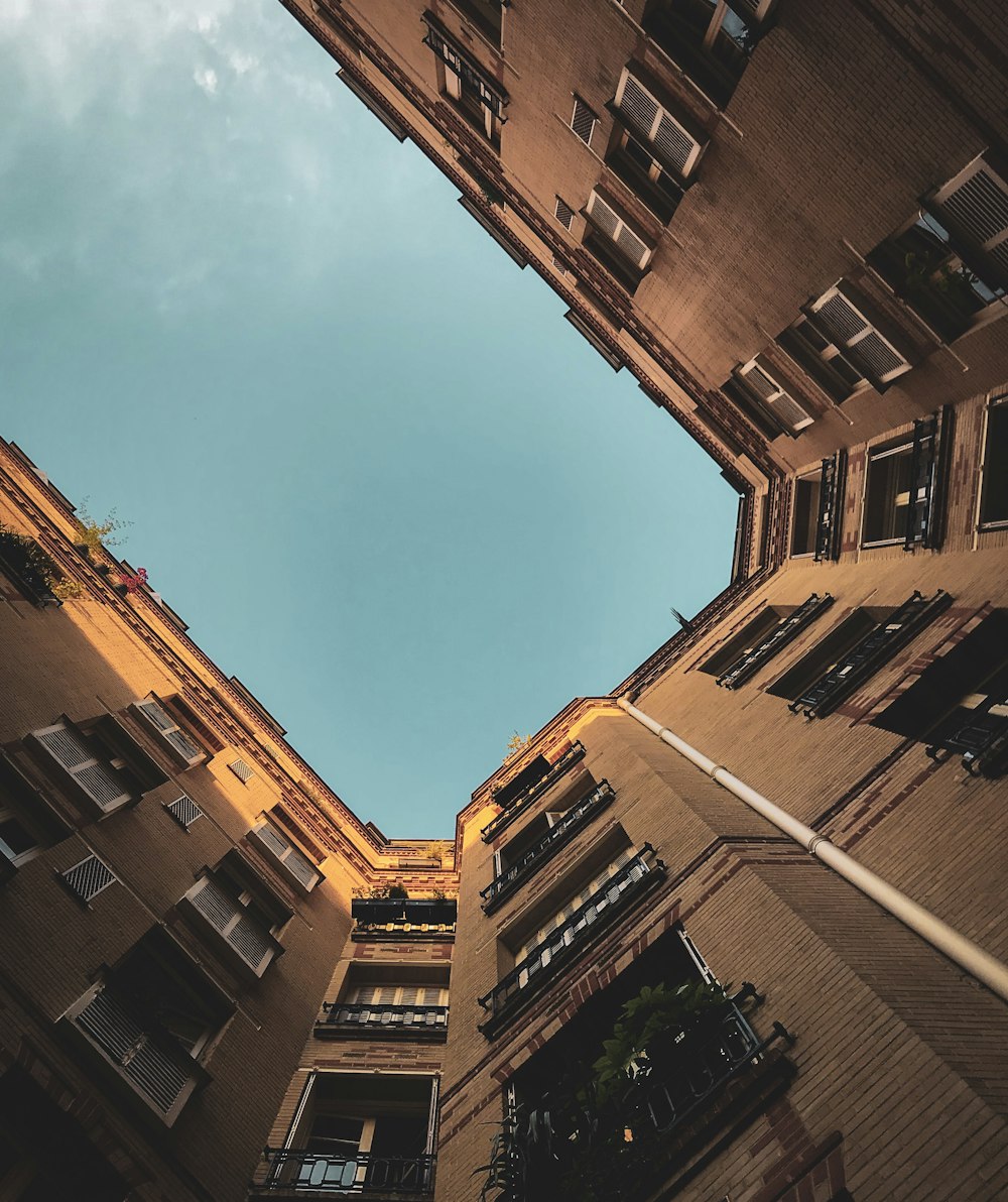 worms eye view of brown concrete building