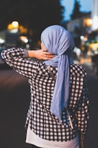 selective focus photograph of person wearing blue headscarf