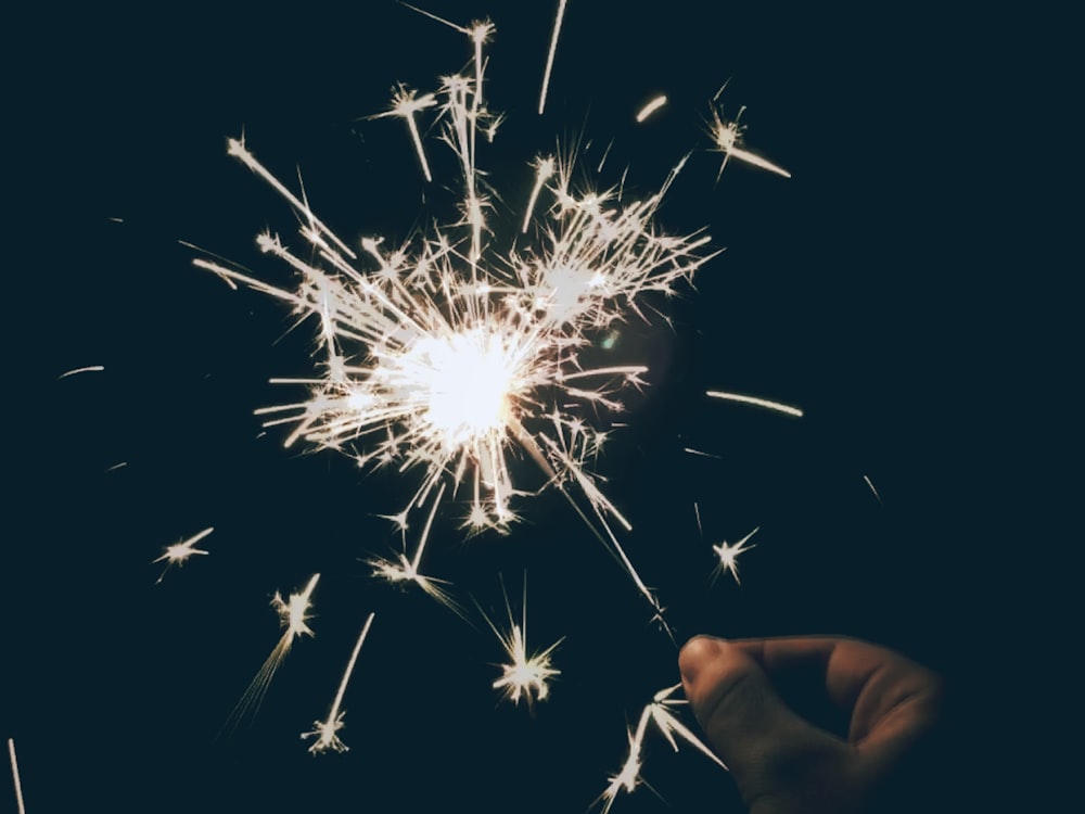 a person holding a sparkler in their hand