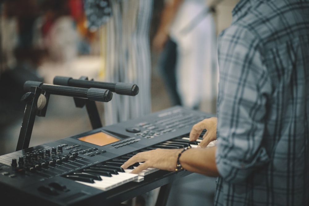 person playing electronic keyboard