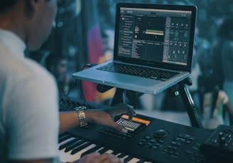 person playing electronic keyboard while recording