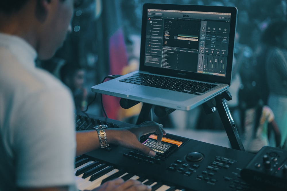 person playing electronic keyboard while recording