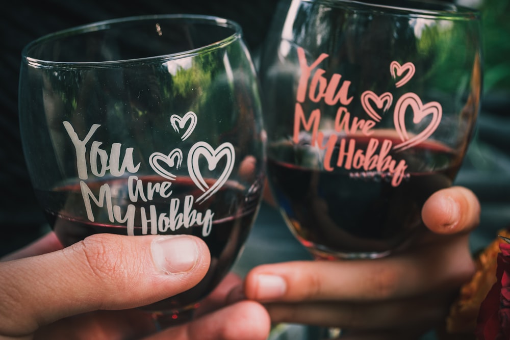 two people toasting wine glasses