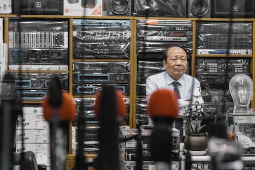 man beside stereo amplifiers