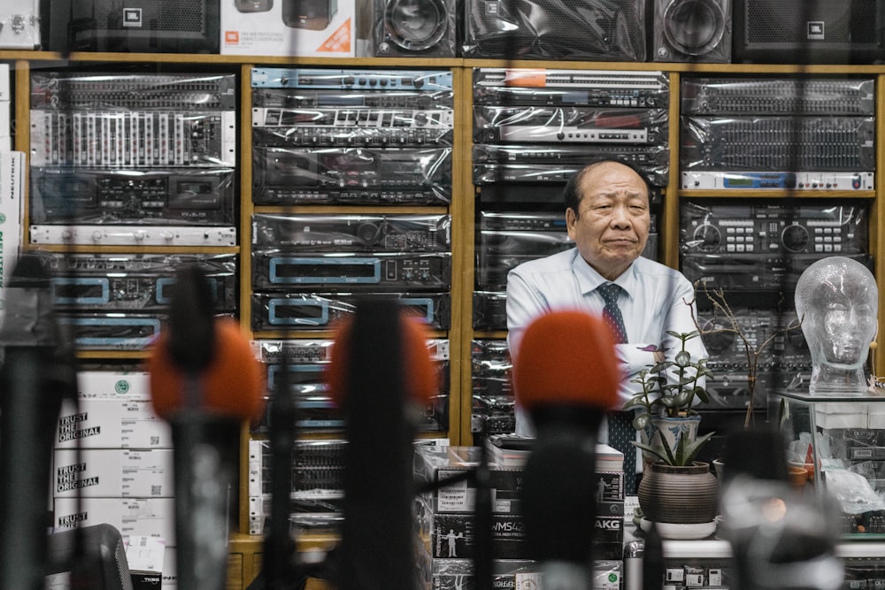 man beside stereo amplifiers