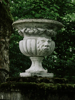 Open cedar urn displaying smooth interior finishing, set against a rustic wooden backdrop