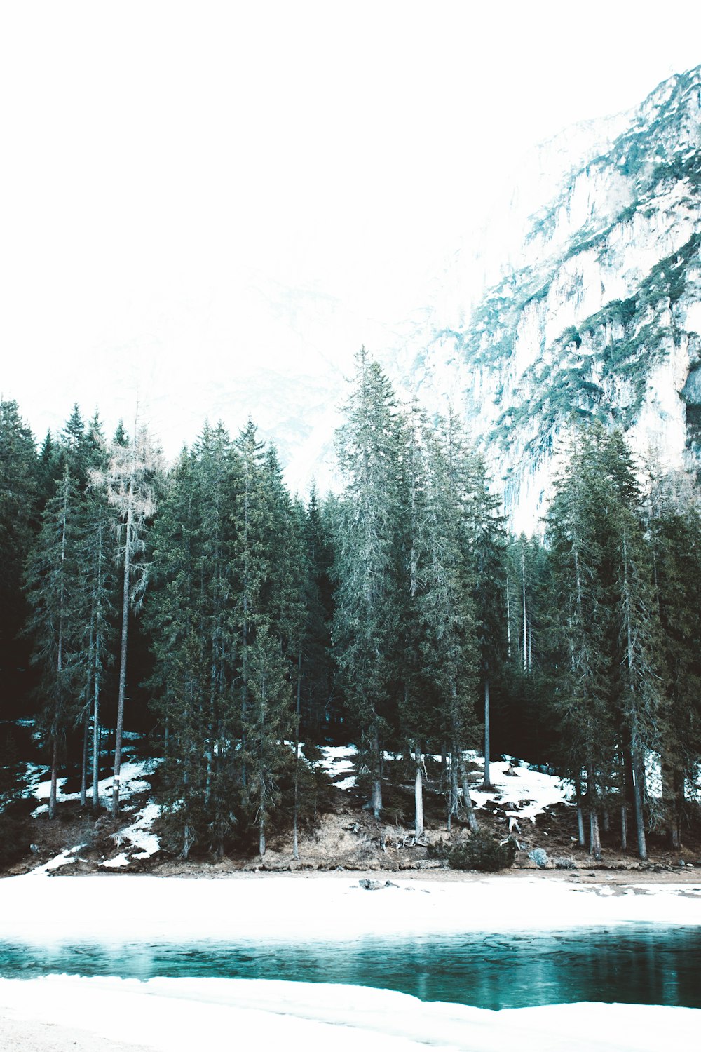 snow-capped mountain under white clouds