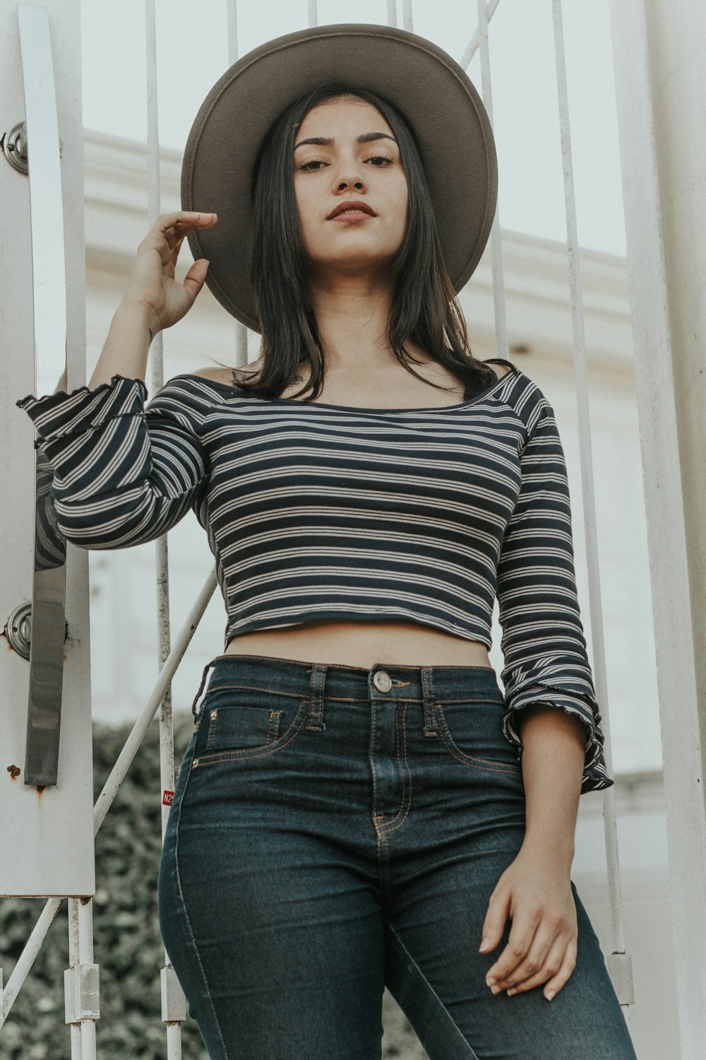 woman holding gray hat