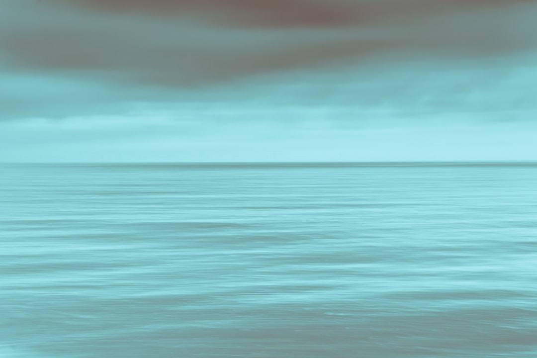 calm sea under gray clouds