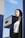 A smiling customer standing at a gas station pump.