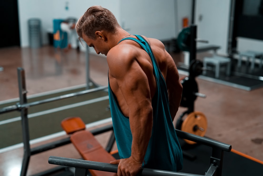 man exercising in dip station