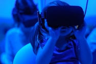 girl joyfully learning to use using VR goggles