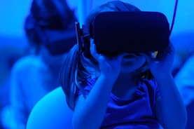 girl joyfully learning to use using VR goggles