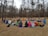 A serene group of diverse people sitting in a circle during a healing ritual outdoors.