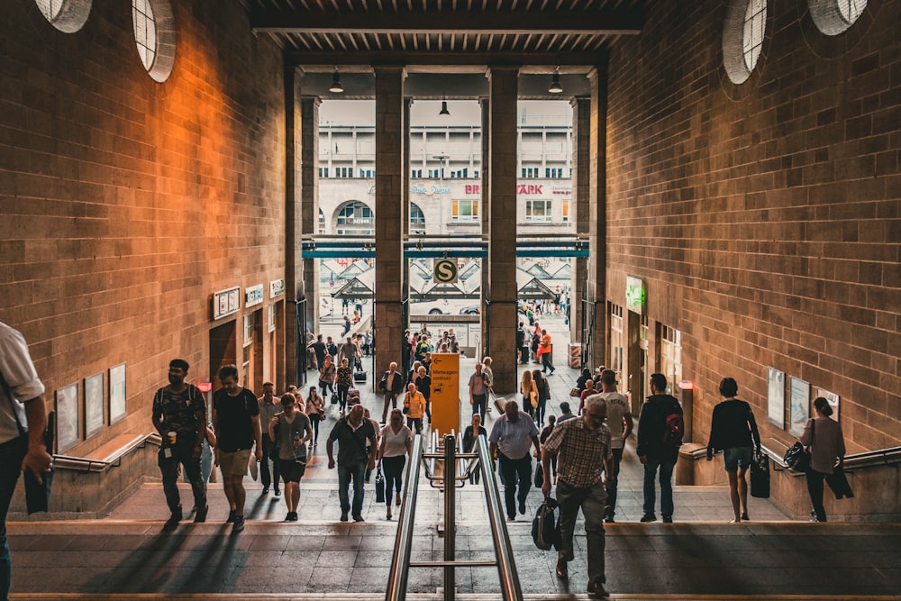 group of people entering a brown hallway