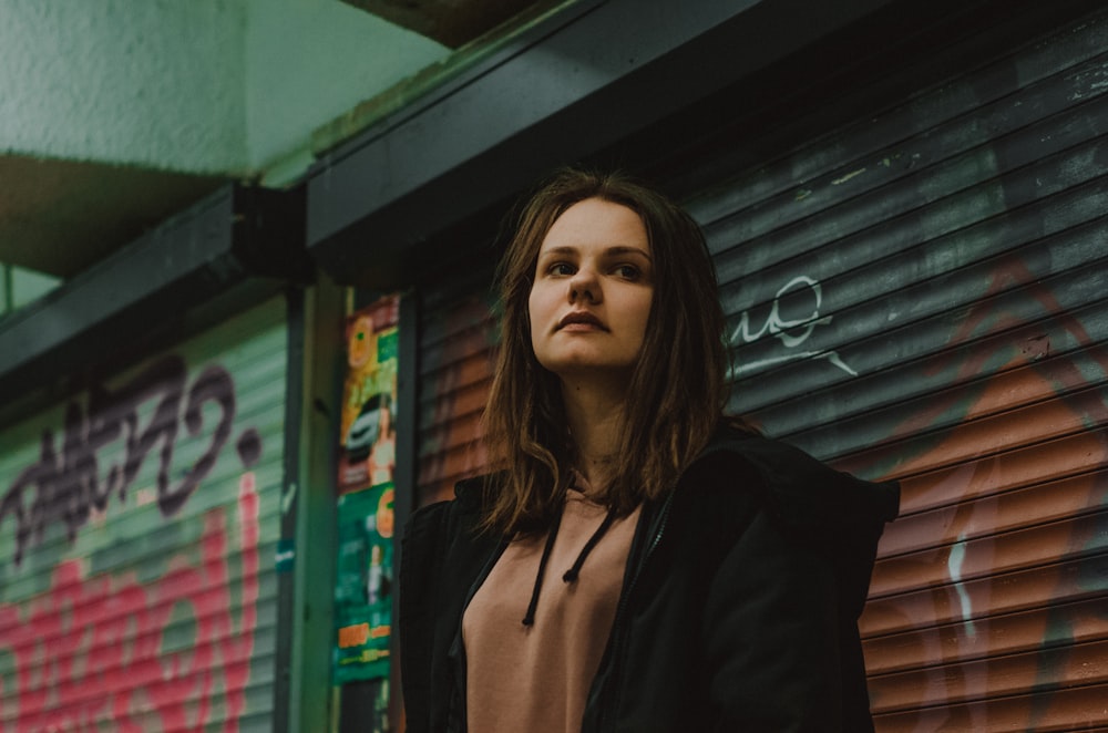 woman in black zip-up jacket and brown top