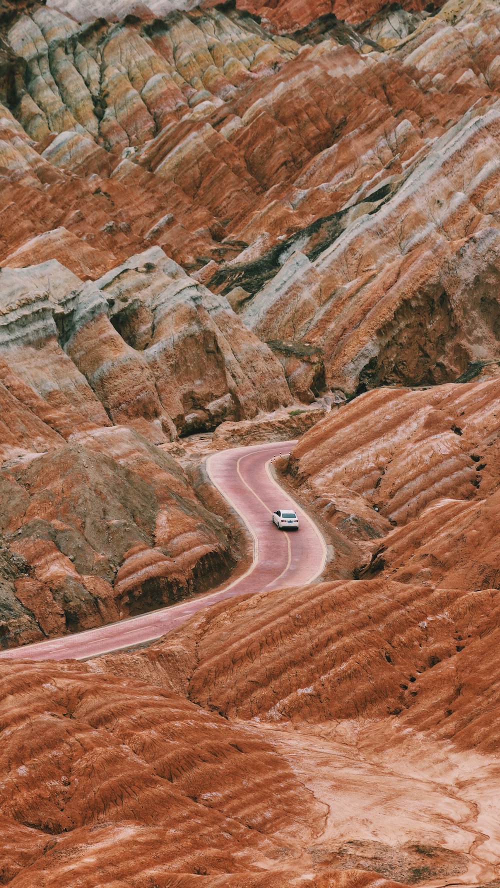 car passing by on zig-zag road