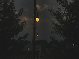 A community space lit up by solar-powered streetlights at dusk.