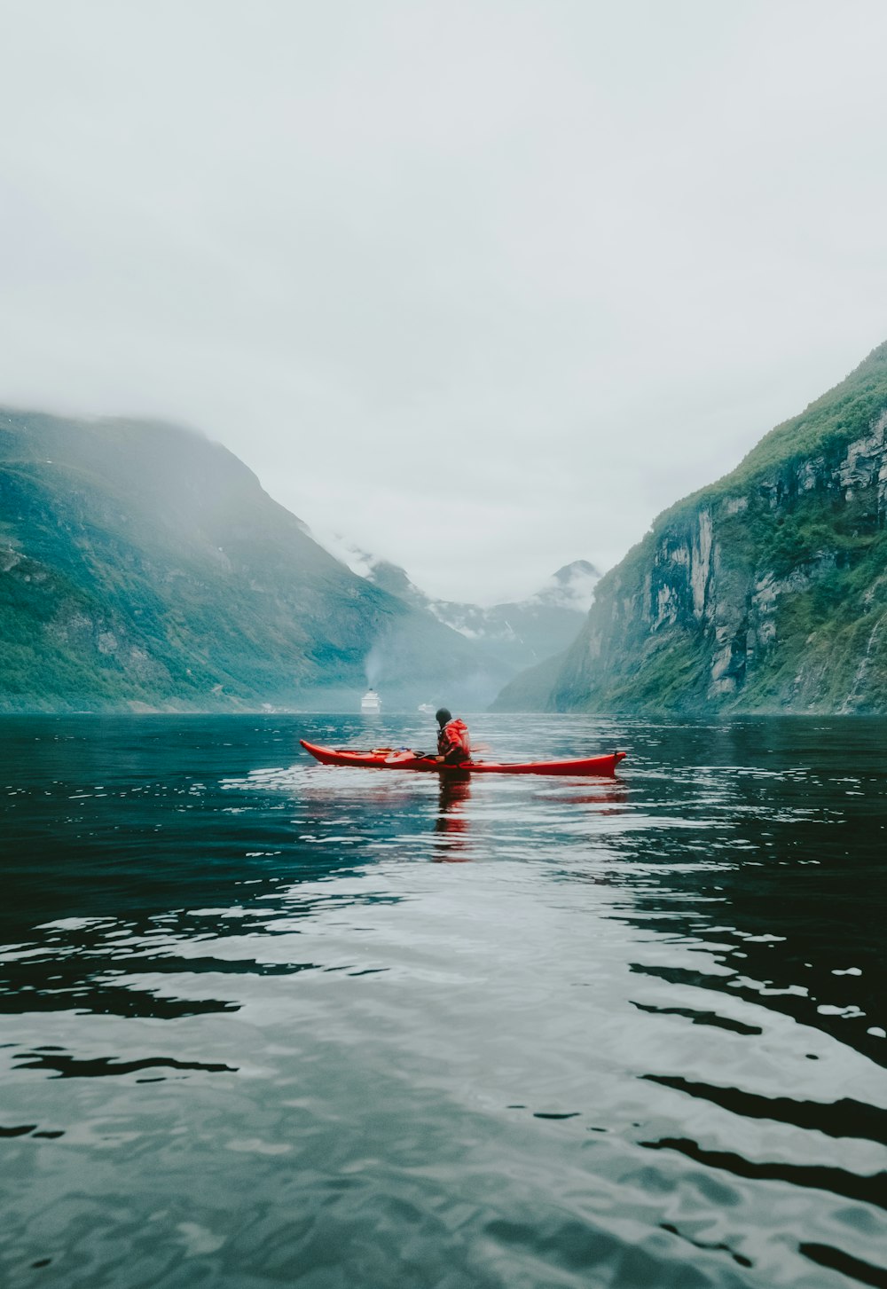 person riding kayak on body of water