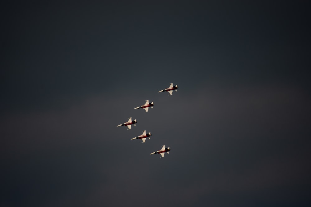 five airplanes having a formation