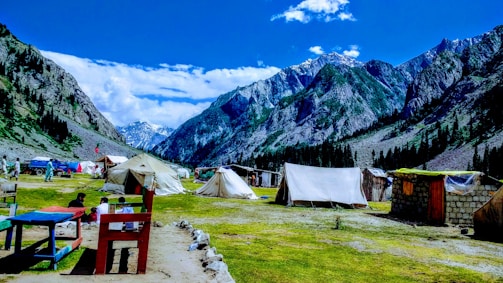 A panoramic shot of a mountain retreat featuring multiple Luxtents.