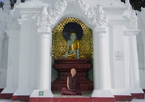 The monk offering a gentle blessing to an elderly person in a quiet temple