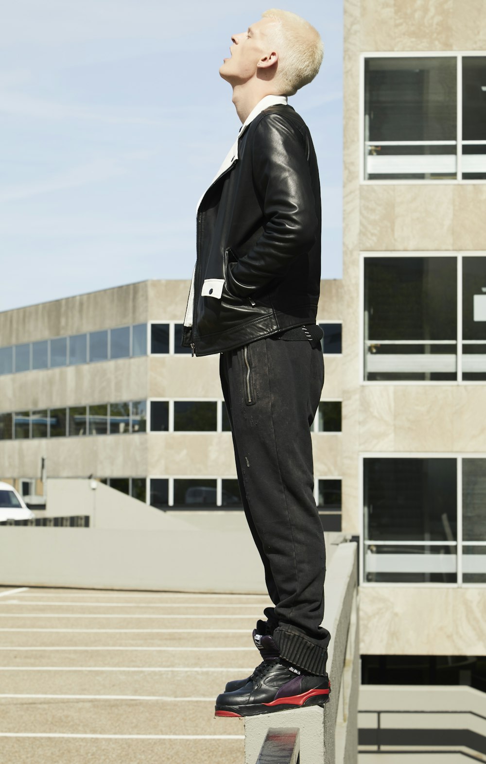 man standing on gray surface near building