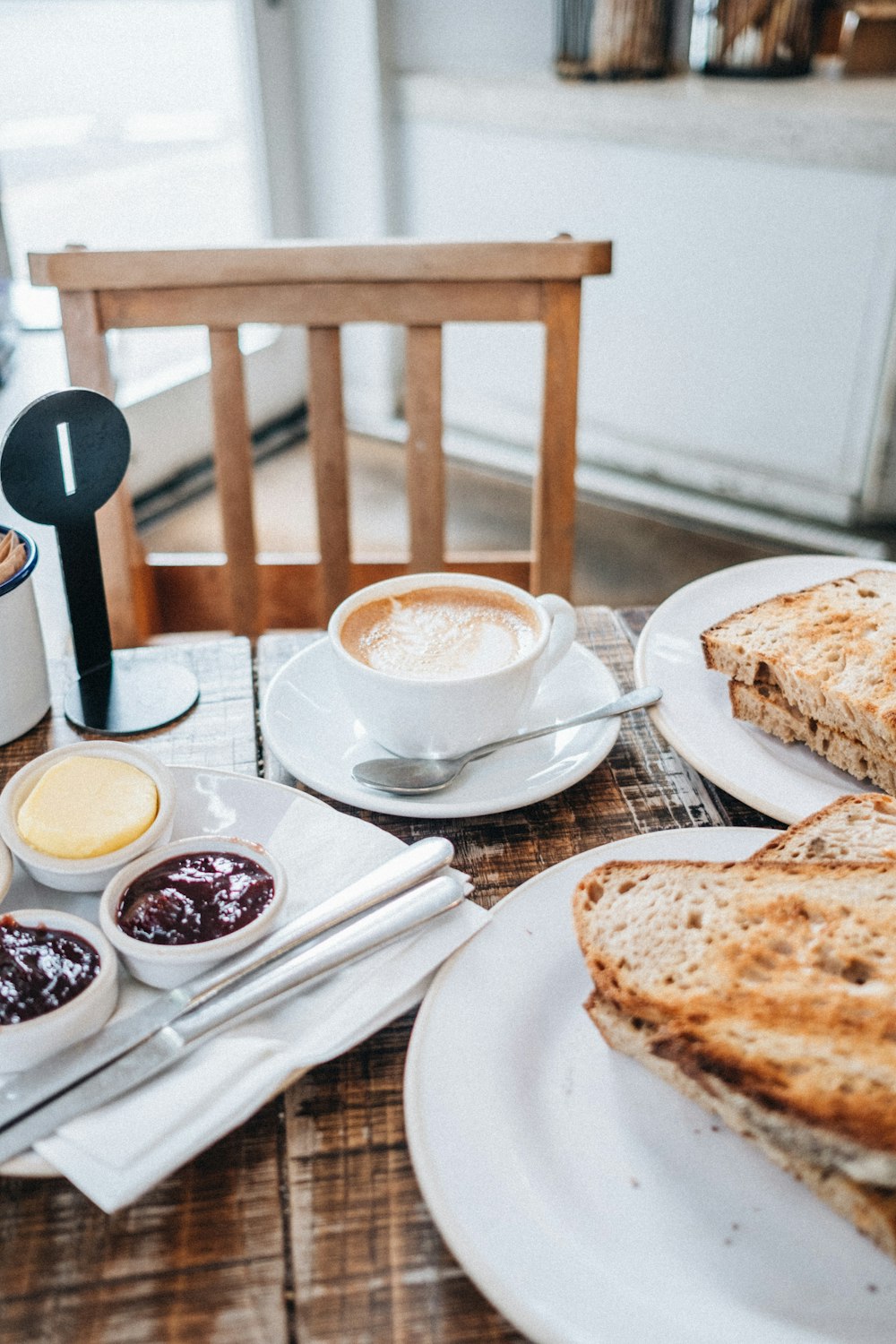 cup of latte and sliced breads