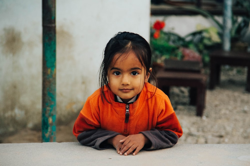 girl leaning over pavement