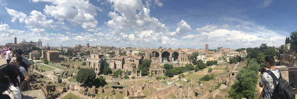 Panoramic view of the ancient ruins at Hampi under a bright midday sun.