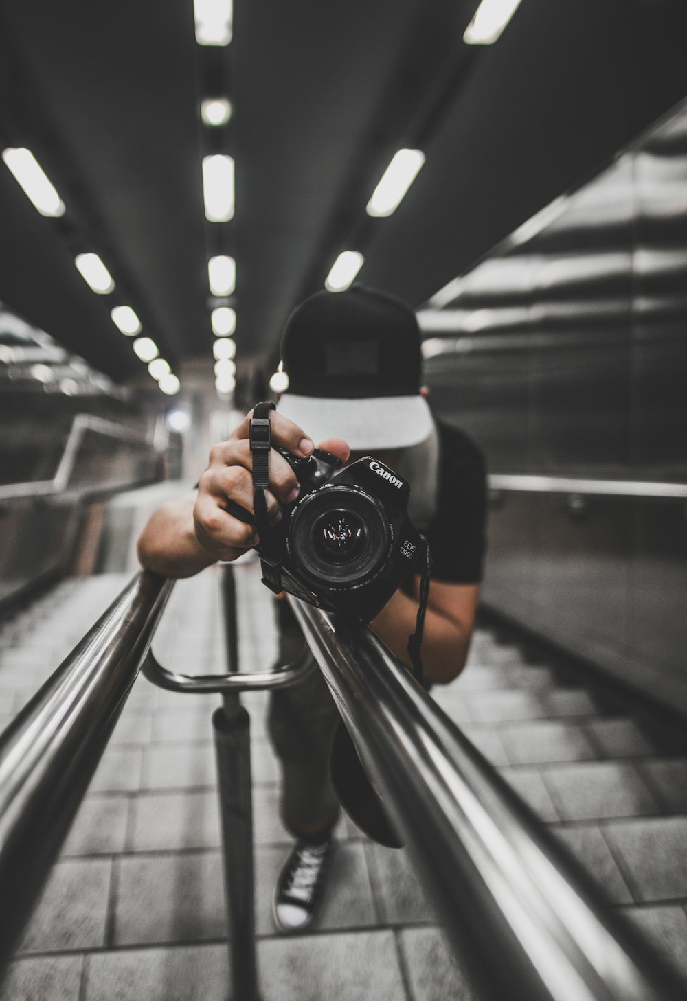 person holding black Canon DSLR camera