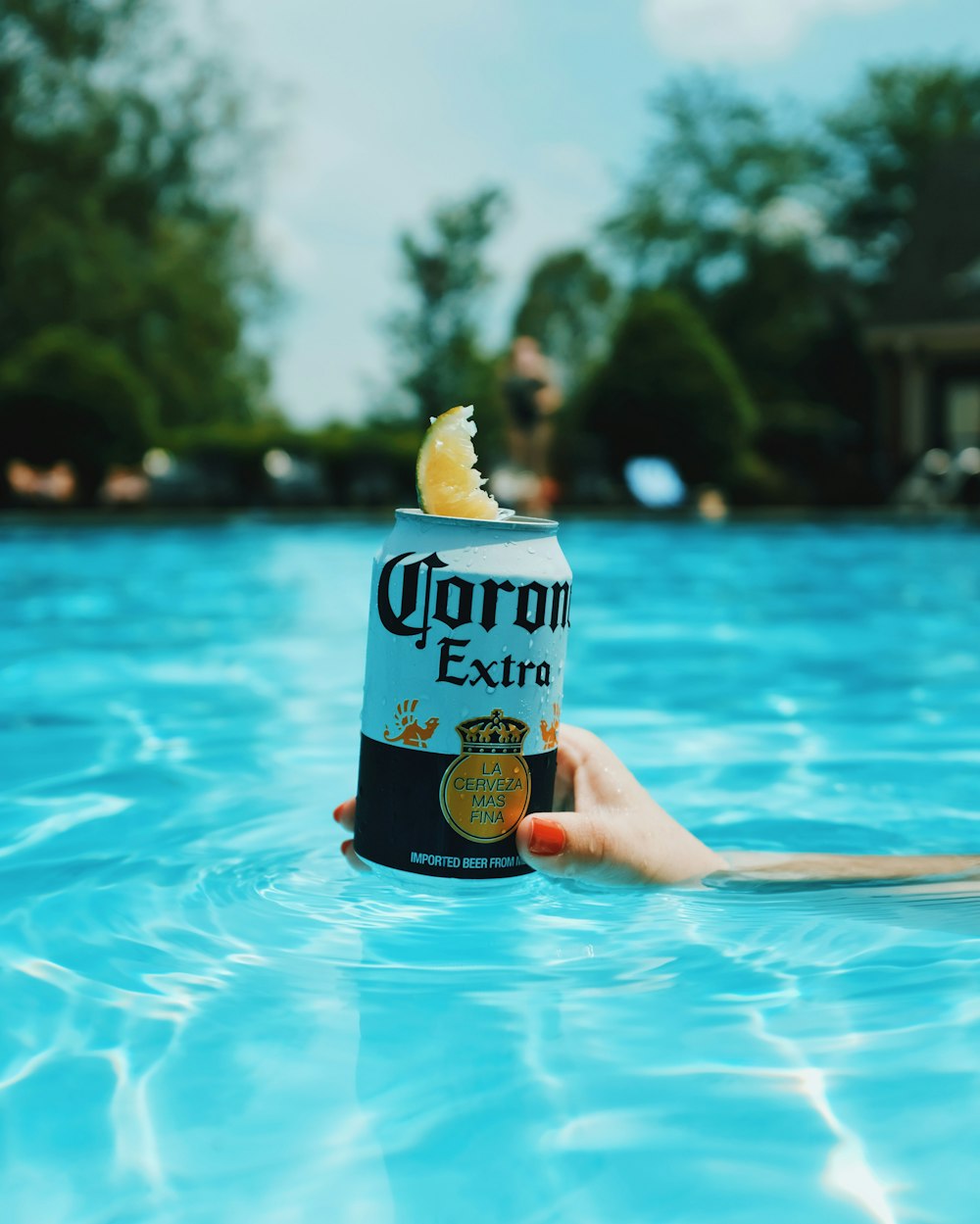 Corona extra beer can on swimming pool