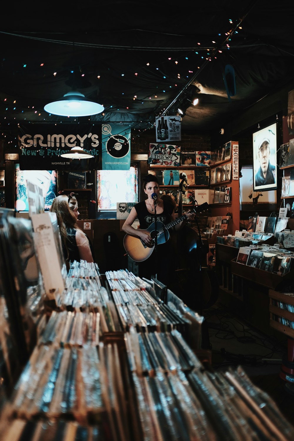 woman sings while playing guitar