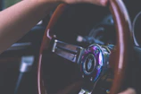 Close-up of a learner's hands on a steering wheel with instructor beside