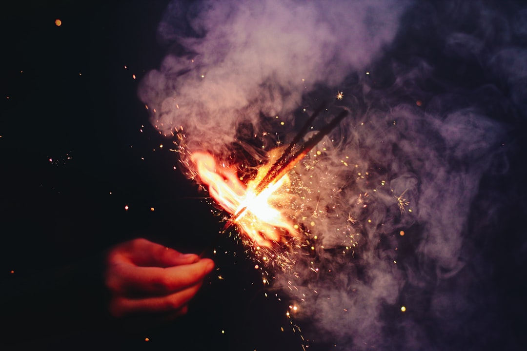 person lighting the sparkler with smoke