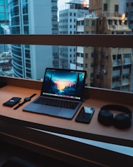 Elegant wooden desk with a modern lamp and a view of the city from the window.