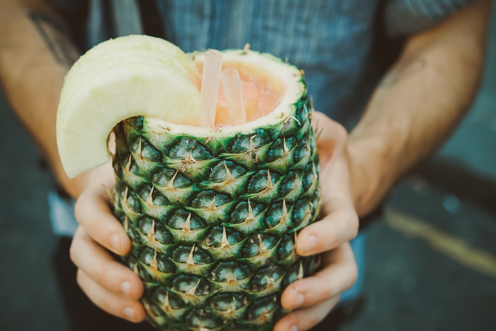 person holding carving pineapple