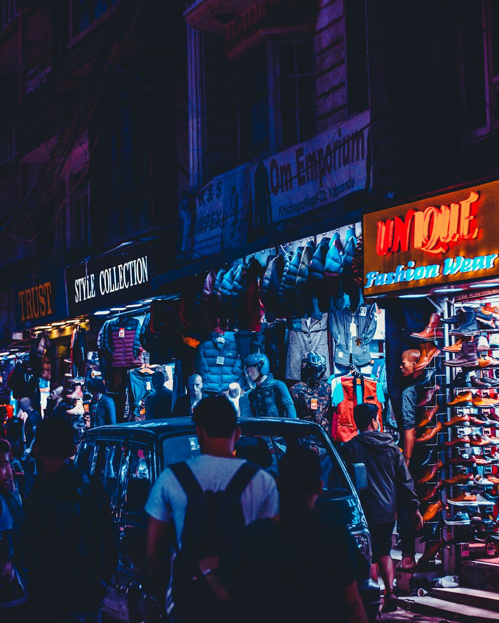 man standing near store facade