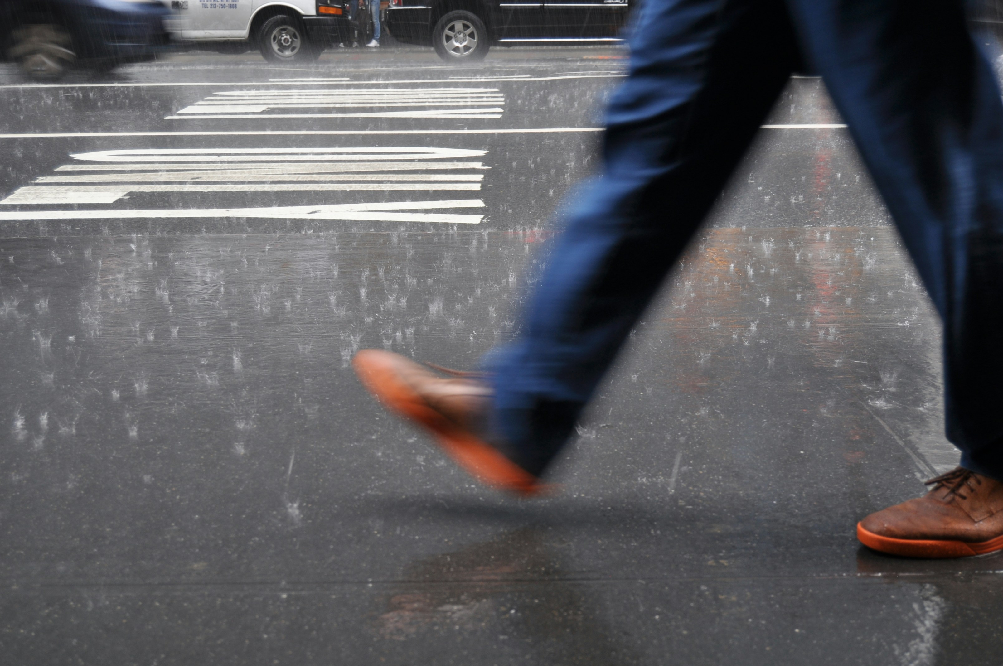 My first trip to New York - I tried to capture the fast and the fury there was there. This was taken while the sky opened up with rain as hard as nails and we were standing in the safe, but this guy defied the rain and just ran towards his purpose