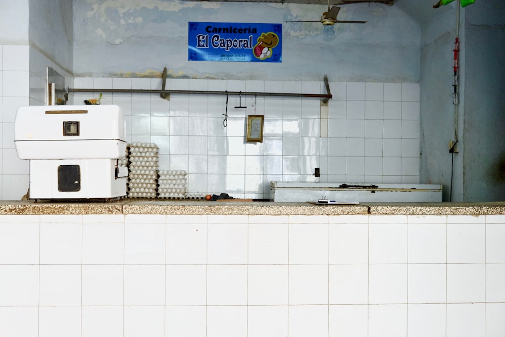 white machine near egg trays on white tiled table