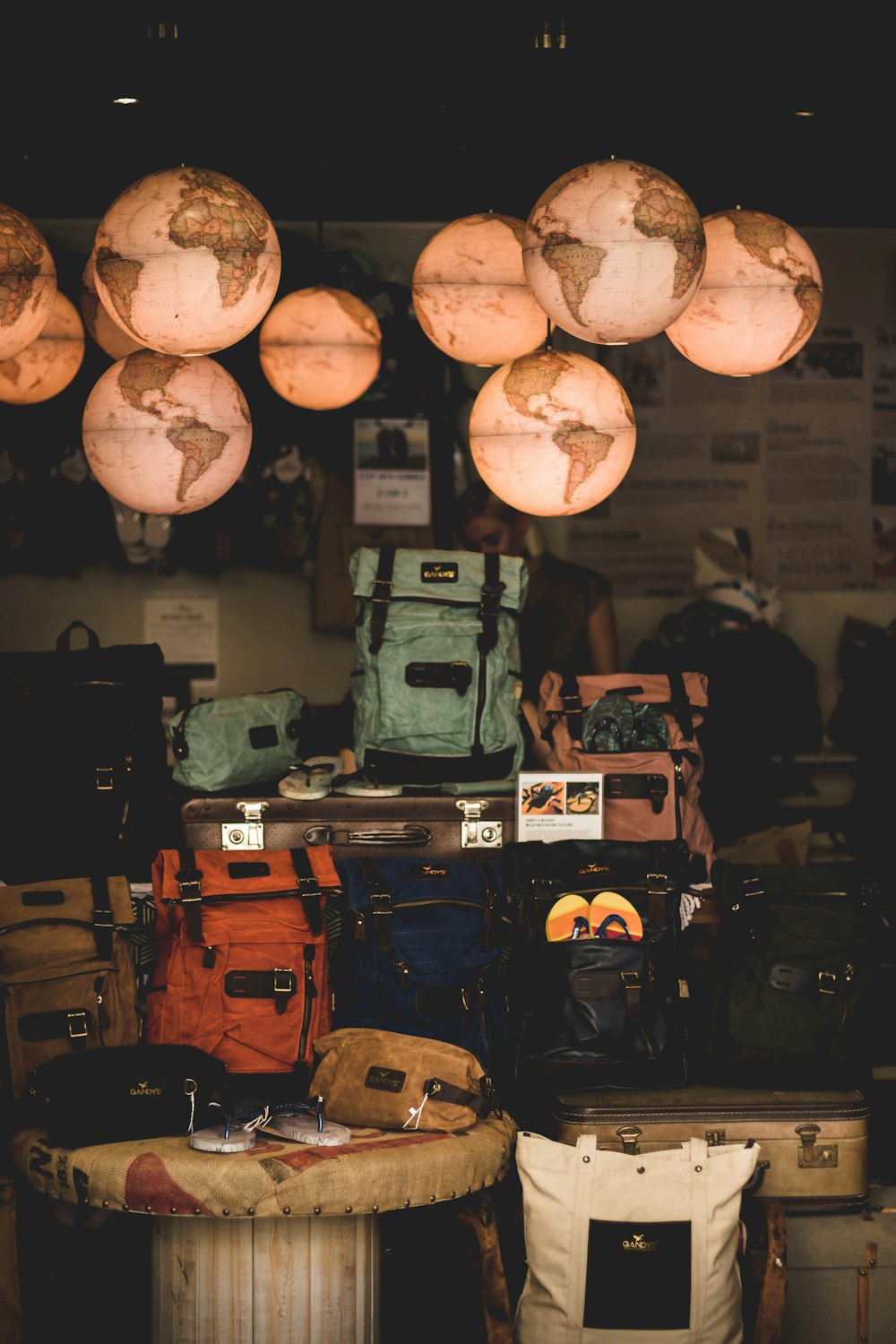 a room filled with lots of luggage and hanging lights