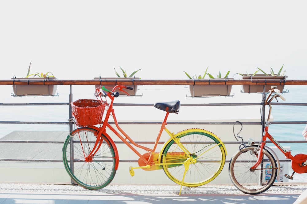 two red bicycles near railing