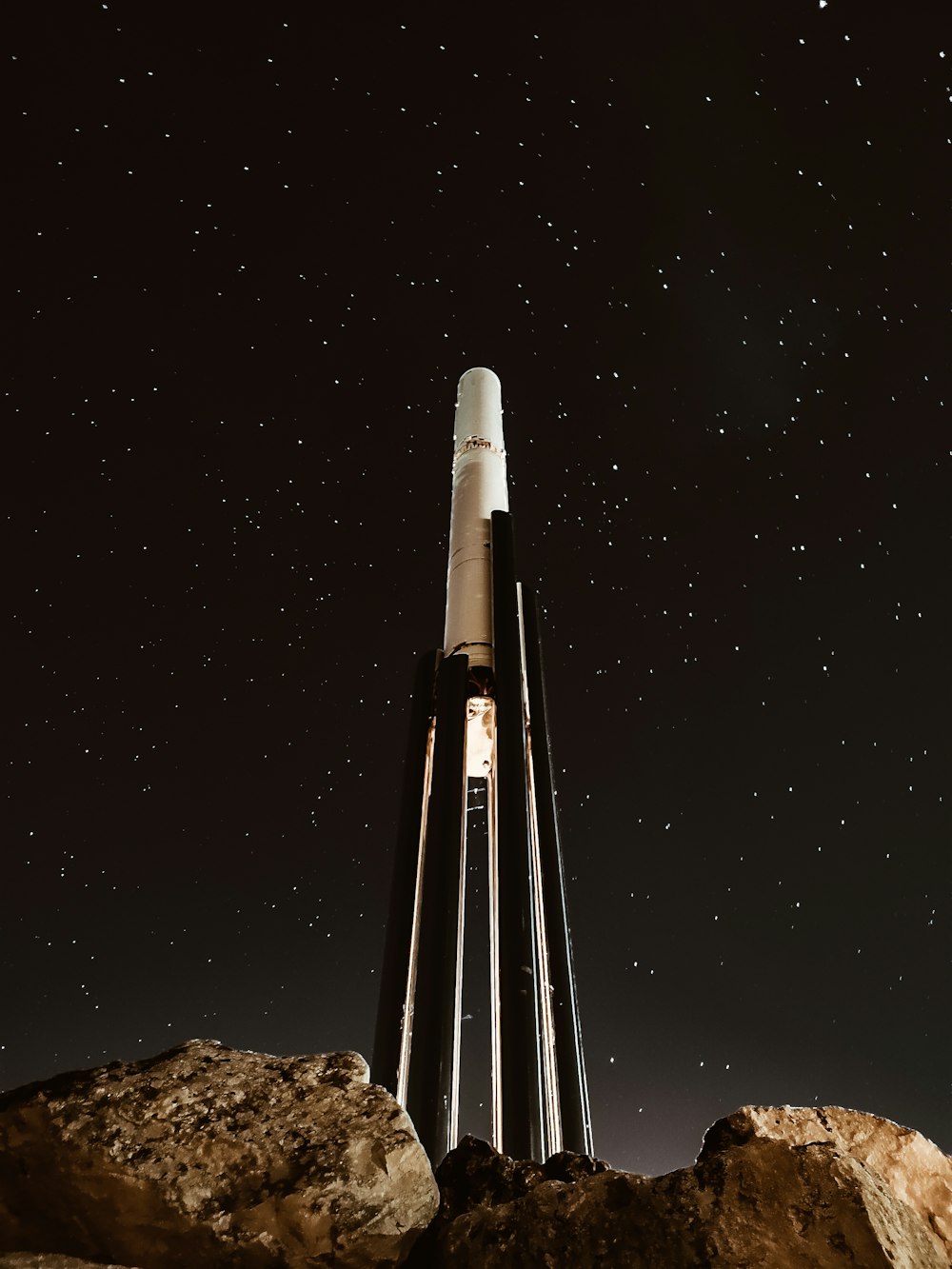 Torre blanca y negra cerca de piedras