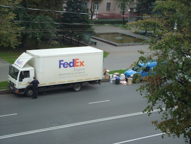 A delivery van parked outside a business, ready to load packages.