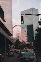 ferris wheel near high rise building during daytime