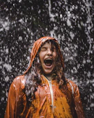 close-up photo of woman in orange coat