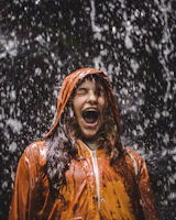 close-up photo of woman in orange coat