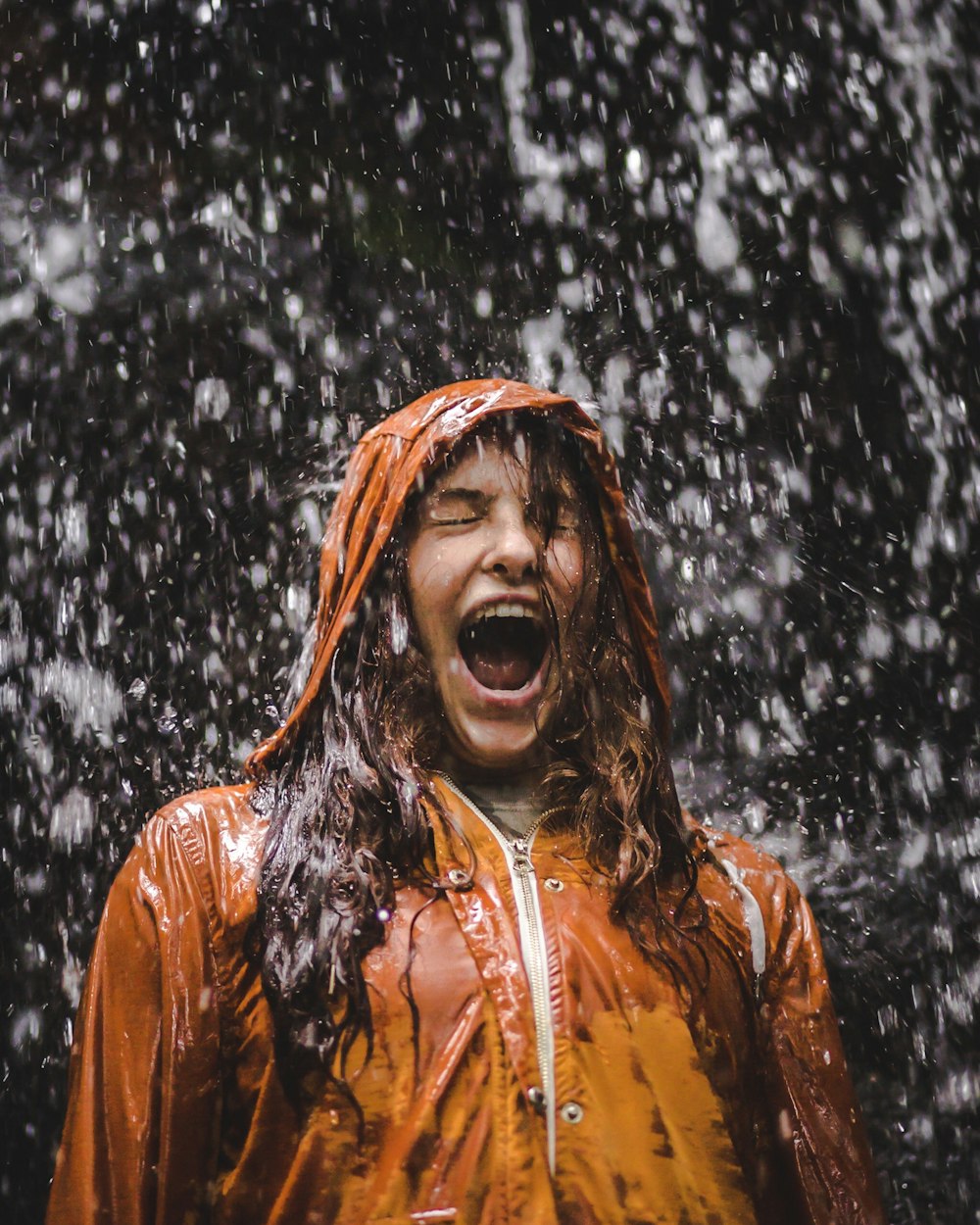 close-up photo of woman in orange coat