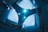 A futuristic architectural ceiling design with a central panel featuring numerous small circular lights and patterns. The surrounding walls are constructed from a sleek, modern material, and the lighting casts a cool blue hue over the entire structure.
