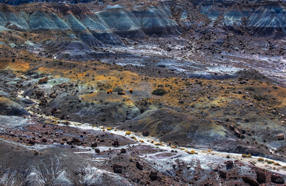 brown and gray hills with stones at daytime